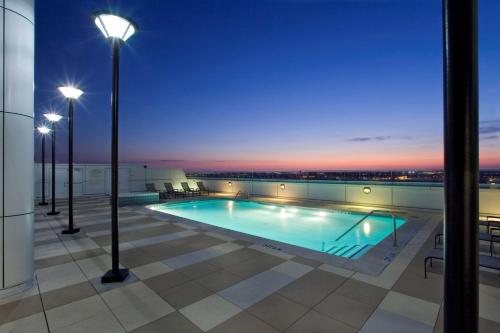a swimming pool on the roof of a building at night at Grand Hyatt DFW Airport in Irving
