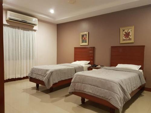 Postel nebo postele na pokoji v ubytování Hotel Subhalakshmi Palace