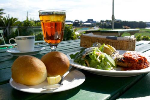 a table with two plates of food and a drink at Minamiboso Asian Garden Villa Shirahama in Minamiboso
