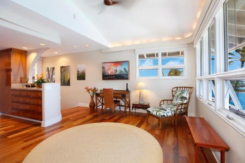 a living room with a table and chairs at Whalers Cove in Poipu in Koloa