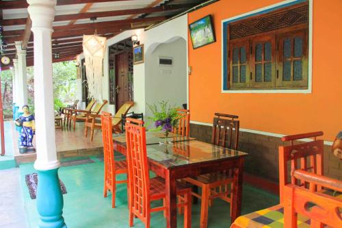 a dining room with a table and chairs at Senura Home Stay in Sigiriya