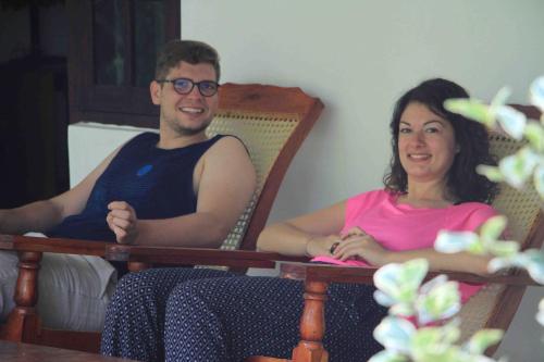 a man and a woman sitting in rocking chairs at Senura Home Stay in Sigiriya