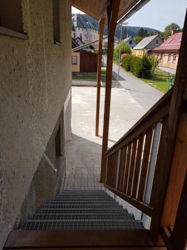 a stairway leading up to a building with a stair case at Apartmány TAS in Jablonec nad Jizerou