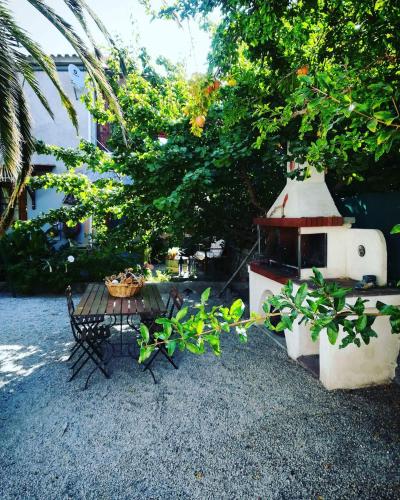 a bird house and a table in a yard at Zaira Studios in Skala Eresou