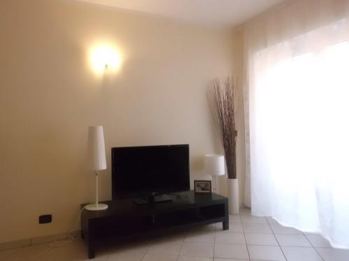 a living room with a flat screen tv on a table at Affittacamere Ca' Fattorini in Baceno