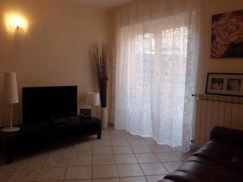 a living room with a couch and a television at Affittacamere Ca' Fattorini in Baceno
