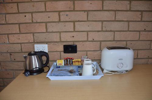 a counter with a coffee maker and a toaster on it at Sunray Motor Inn in Toowoomba