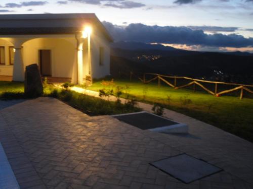 a house with a light on the side of it at Agriturismo Irghitula in Posada