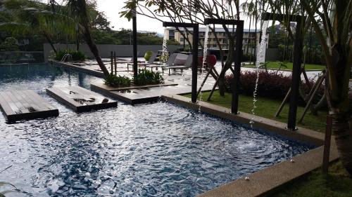 a swimming pool with a swing in a backyard at Adna Homestay Wangsa Maju in Kuala Lumpur