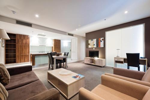 a living room with a couch and a table at Embassy 2br free parking in Adelaide