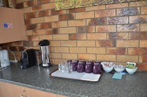 a kitchen counter with a tray of glasses on it at Sunray Motor Inn in Toowoomba