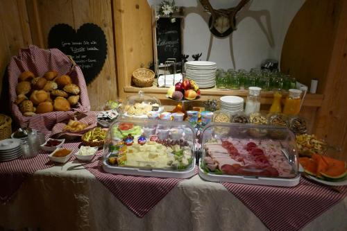 a table topped with trays of food on a table at Landhaus Krone in Steinach