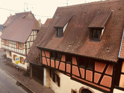 a group of buildings with brown roofs at Hotel Colmar Vignes Eguisheim in Eguisheim