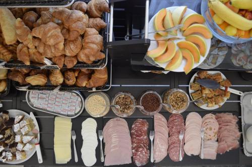 a bunch of different types of food on display at Hotel Happy in Marina di Pietrasanta