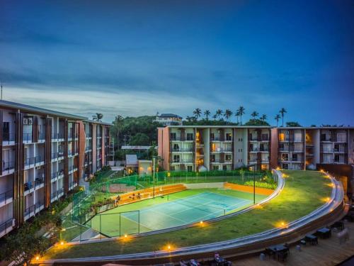 an apartment complex with a tennis court in the middle at Replay Condo Studio Room in Bang Rak Beach