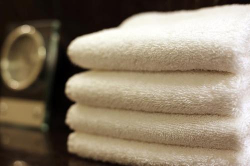 a stack of white towels stacked on top of each other at Shangri-La Manzhouli in Manzhouli