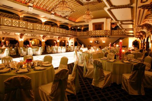 a banquet hall with white tables and chairs at Millennium Knickerbocker Chicago in Chicago