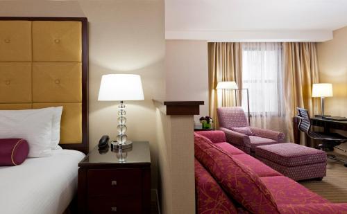 a hotel room with a bed and a desk at Millennium Knickerbocker Chicago in Chicago