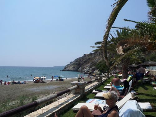 a group of people sitting on the beach at Olea Escape Villa in an Olive Estate in Gythio