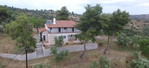 a house on top of a hill with trees at Olea Escape Villa in an Olive Estate in Gythio