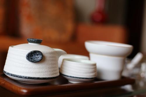 a tray with white cups and a teapot at Shangri-La Manzhouli in Manzhouli
