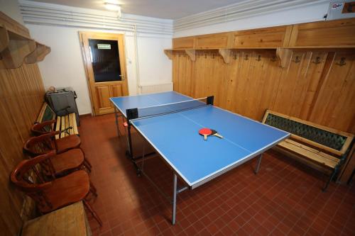 a blue ping pong table in a room at Rejteki Kutatóház in Bükkszentkereszt
