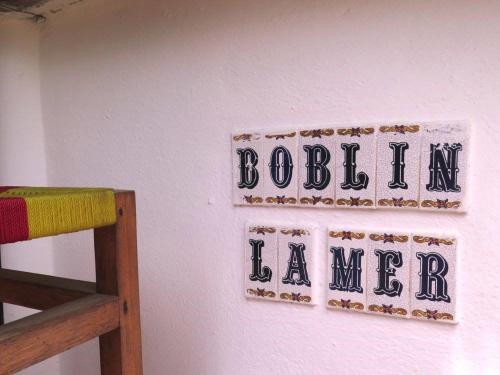 大巴薩姆的住宿－Boblin la Mer hotel restaurant plage，墙上的标志,上面写着“bostonianeianeaiden”字样