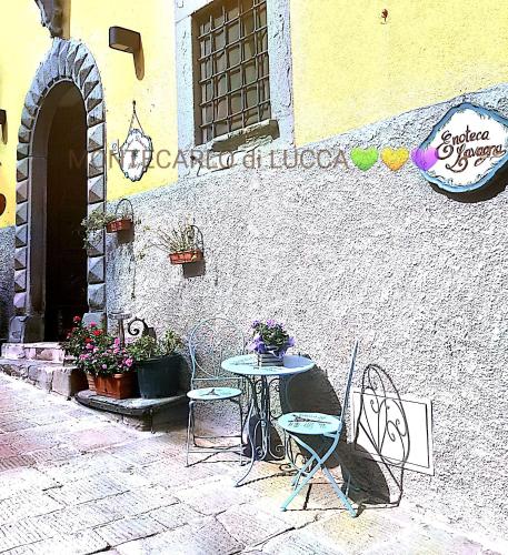 a table and chairs sitting outside of a building at Antica Dimora Patrizia in Montecarlo