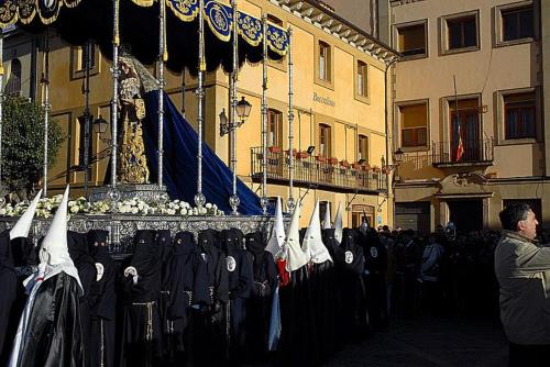 a man standing in front of a display of clothes at Hostal Restaurante Boccalino in León