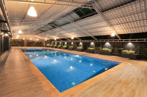 a large swimming pool in a building at D Fort Hotel Kollam in Kollam