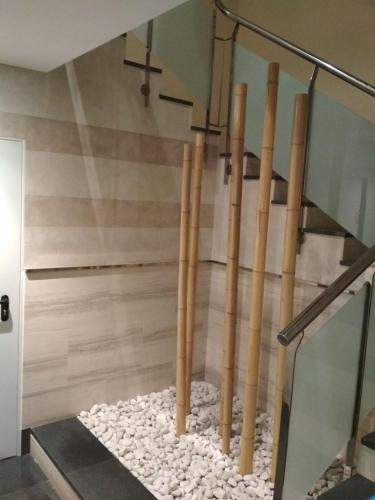 a staircase with bamboo poles in a room at Ático Vista Alegre in Lerma