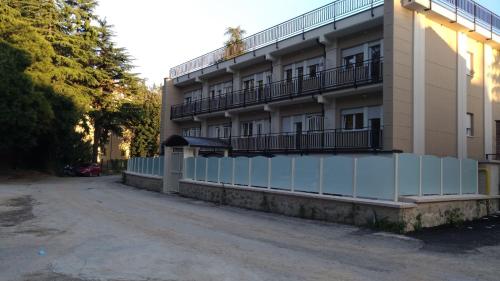 a building with balconies on the side of it at Casa Ospitalità San Giuseppe in LʼAquila
