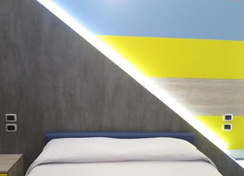 a bedroom with a bed with a beam of light at B&B Carrabs in Battipaglia