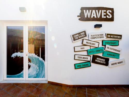 a bunch of signs on a wall next to a door at Ramada Hotel & Suites by Wyndham Costa del Sol in Fuengirola
