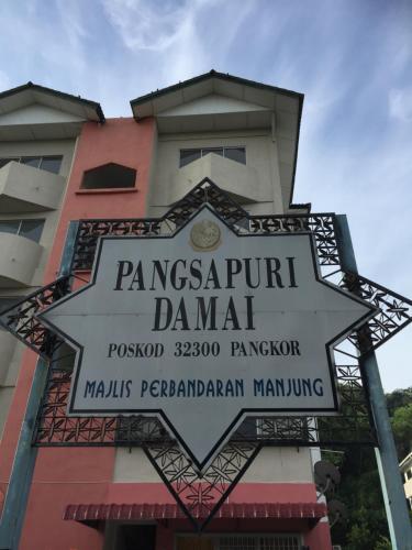 a sign in front of a building at Pangkor Damai in Pangkor