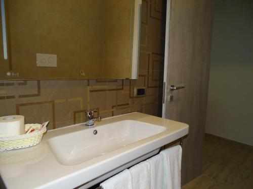 a bathroom with a white sink and a mirror at B&B Carrabs in Battipaglia