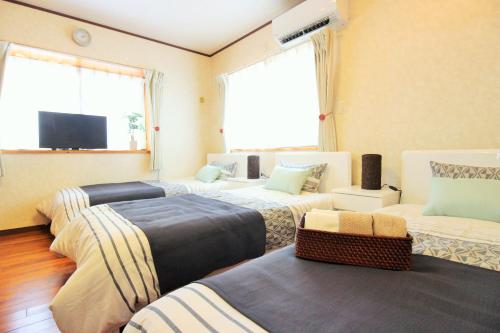Voodi või voodid majutusasutuse Resort Villa The ReLa Inn toas