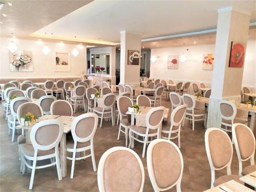 a dining room with tables and chairs in it at Grenada Hotel in Sunny Beach