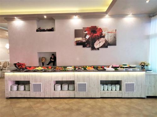 a display counter with plates of food on it at Grenada Hotel in Sunny Beach