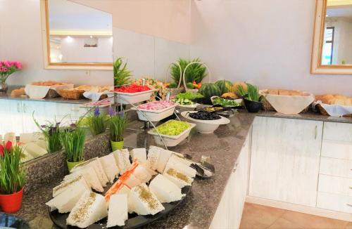 a buffet of food on a counter in a room at Grenada Hotel in Sunny Beach
