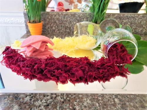 a white tray with red flowers on a counter at Grenada Hotel in Sunny Beach