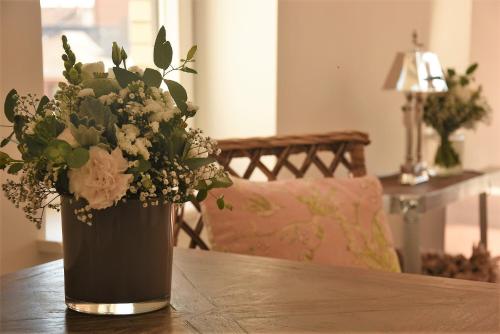 a vase of flowers sitting on a wooden table at Boutique Hotel Villa Monika in Westerland (Sylt)