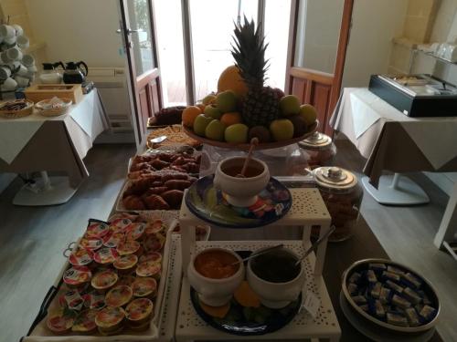 a table filled with different types of food at Aegusa Hotel in Favignana