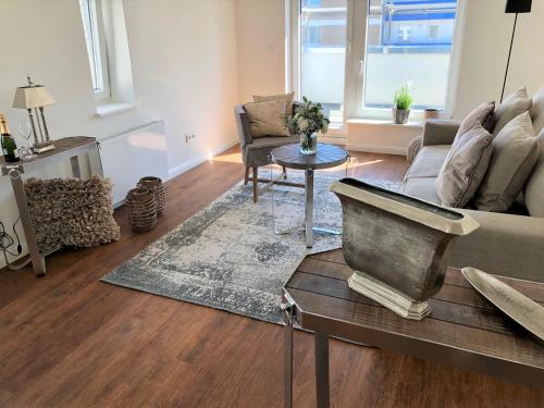 a living room with a couch and a table at Boutique Hotel Villa Monika in Westerland (Sylt)