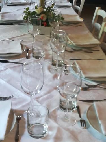 a table with wine glasses on a white table cloth at Società Agricola F.lli Angelucci in Cannara