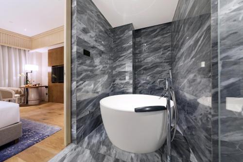 a bathroom with a white tub in a room at The Anandi Hotel and SPA - Luxury Healing Hotel for Wellbeing in Shanghai