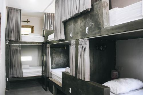 a group of bunk beds in a room at Mellow Hostel in Kuta Lombok