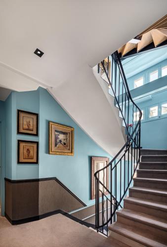 a staircase in a building with blue walls at Hotel Villa Nicolo - Tour Eiffel in Paris
