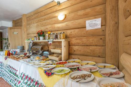 a table with many plates of food on it at Willa Baciarka-basen, sauny i jacuzzi in Kościelisko