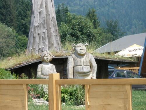 a statue of two people standing next to a tree at Wellness Hotel Bahenec in Bahenec